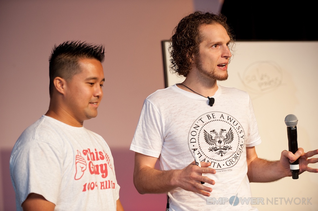 Two presenters teaching side by side in front of a whiteboard at Empower Network's 2012 Atlanta event