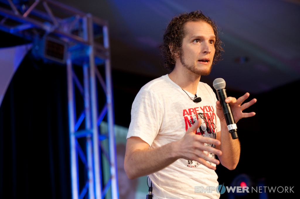 Speaker gesturing expressively with both hands while teaching on stage at Empower Network's 2012 Atlanta event