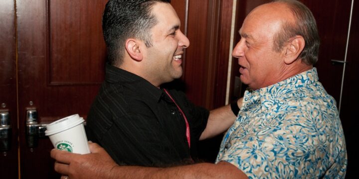 Two attendees greeting each other with a warm embrace at Empower Network's 2012 Atlanta event
