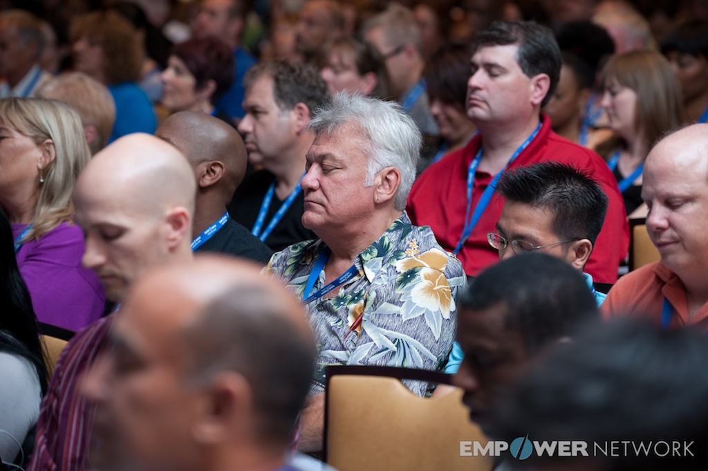 Audience members seated with eyes closed during a reflective exercise at Empower Network's 2012 Atlanta event
